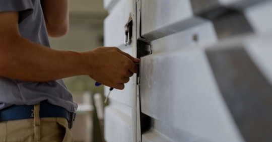 man installing new garage door panel